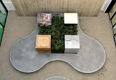 In the courtyard of the Midori-kan, a monument for safety and health surrounded by five materials symbolizing our business has been installed. The design employs a green cross representing safety.